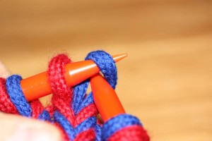 One option: realign the stitch to be pulled over so the left leg is in front of the needle.