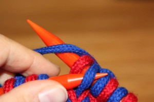 Wrapping yarn the other way around, so the left leg of the stitch will lie in front.