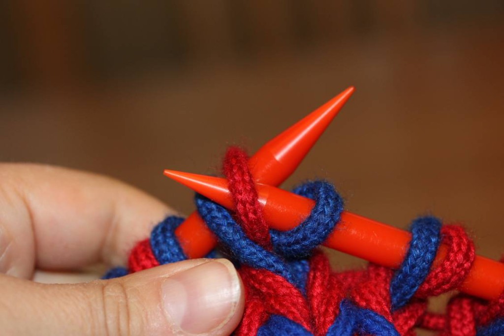 ... and transfer first stitch on left needle to right, dropping the second stitch off the needles.