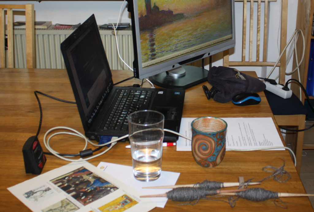 Setup for the online spinning workshop, with two screens and spindles on a table